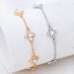 Bracelet with four white rhinestone four-leaf clovers oval fine mesh